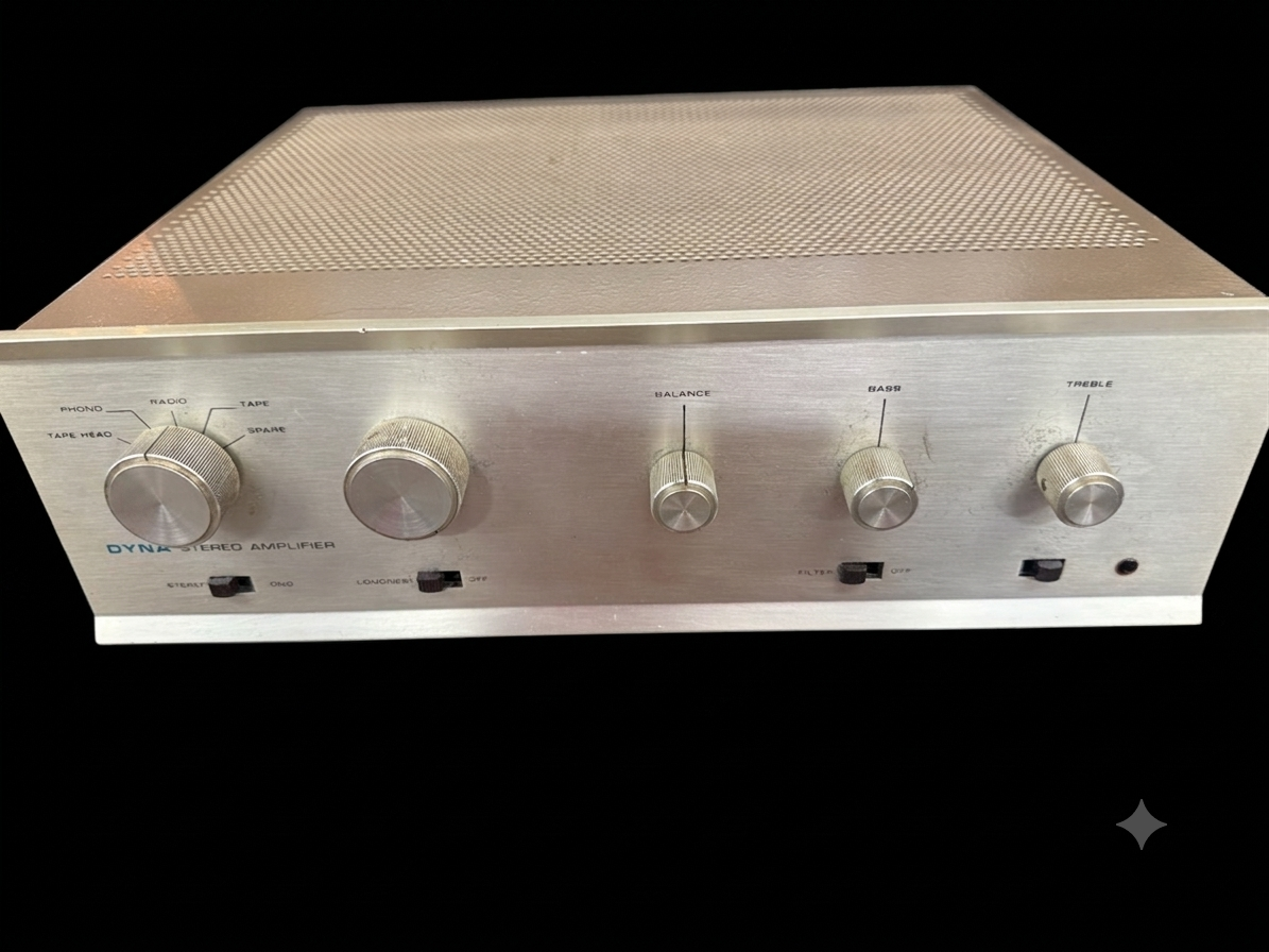 Vintage silver-faced stereo amplifier with five control knobs and switches, photographed against a black background.